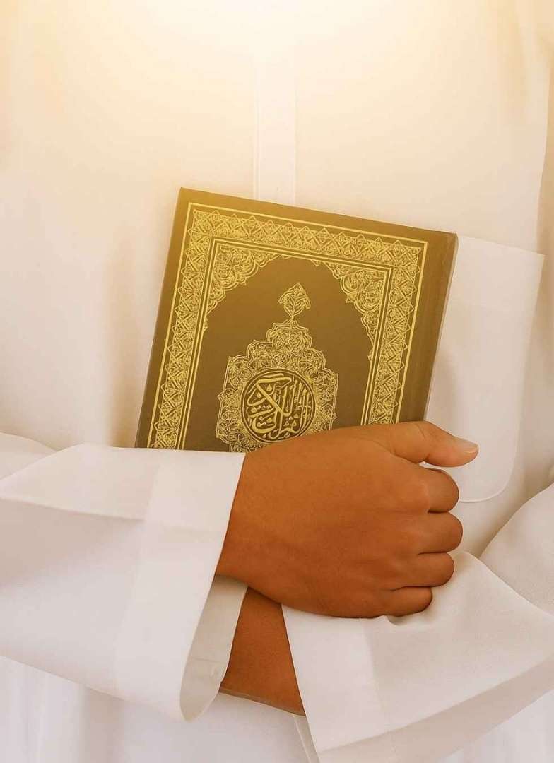 An Adult is Reading the Quran
